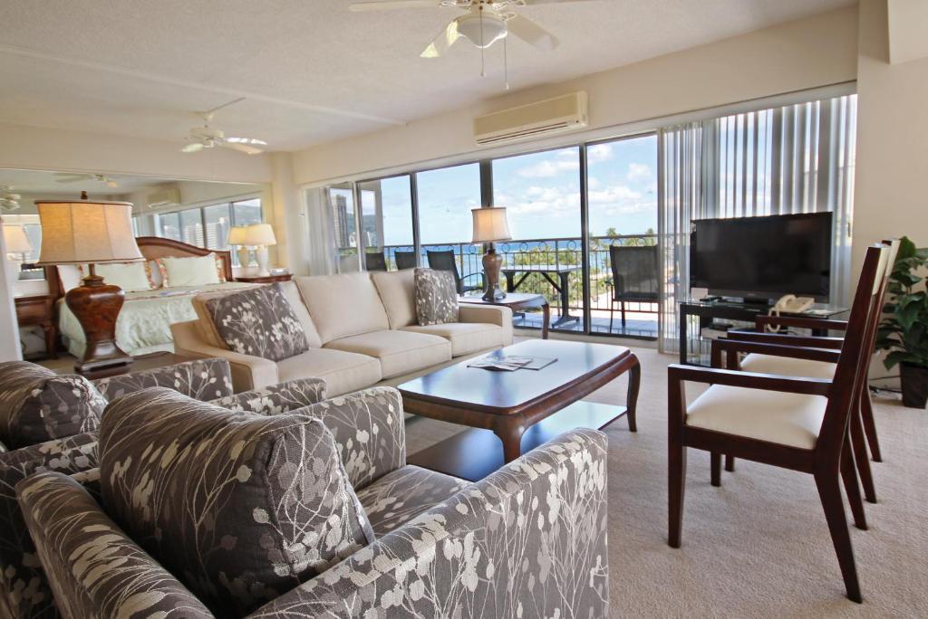 a living room with a couch and a television at Castle Waikīkī Shore in Honolulu