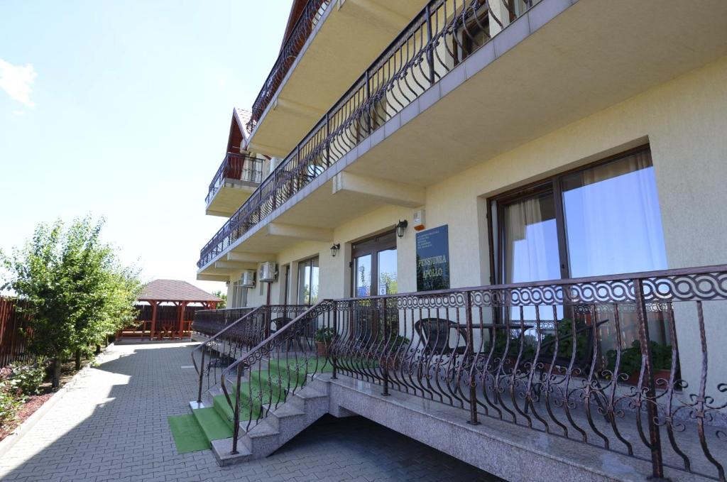 a balcony of a building with a bench on it at PENSIUNEA APOLLO in Costinesti