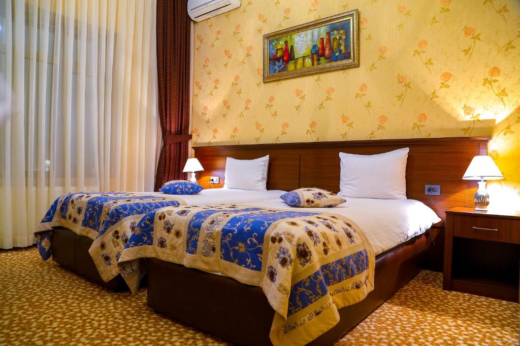 a hotel room with two beds in a room at Central Park Baku in Baku