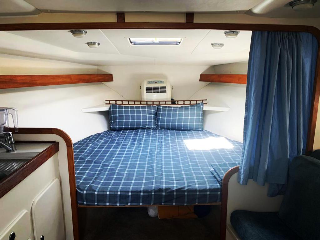 a small bed in the back of a boat at Cozy private two rooms yacht in Barcelona - boat in Port Forum in Barcelona