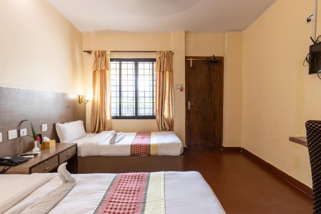 Postel nebo postele na pokoji v ubytování Siddhartha Cottage Butwal
