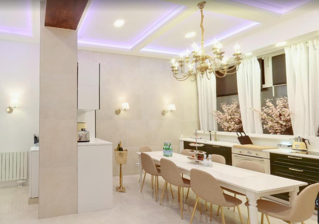 a kitchen and dining room with a white table and chairs at Hevals Palace in Berlin