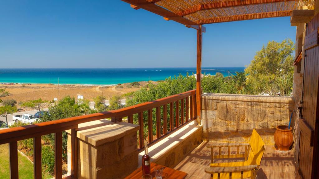 a balcony with a view of the ocean at Golden Sun Apartments in Falasarna