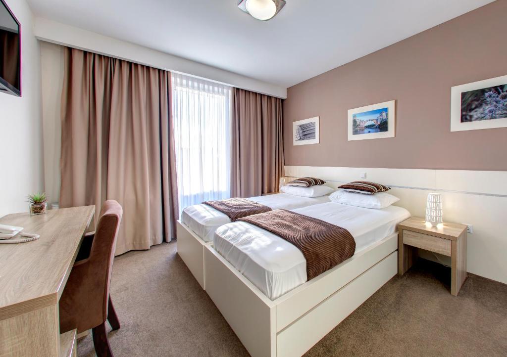 Postel nebo postele na pokoji v ubytování Hotel Argentum