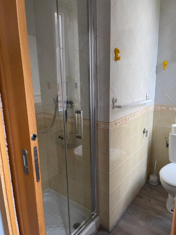 a shower stall in a bathroom with a toilet at Appartement vue sur l ocean in Hendaye