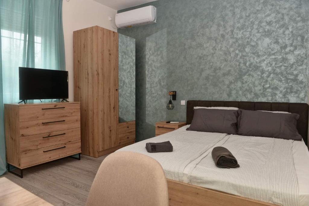 a bedroom with a bed and a flat screen tv at 4-teen in Jagodina