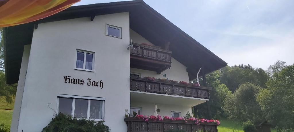 a white house with a balcony on the side of it at Haus Zach in Mariazell