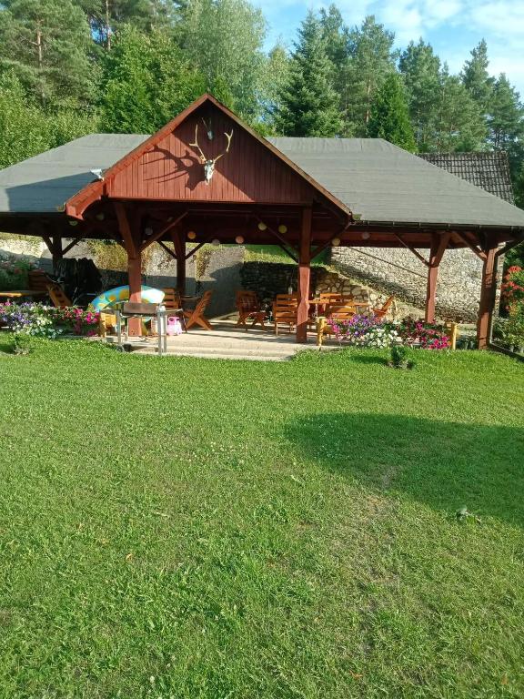 a pavilion in a park with a grass field at Agroturystyka Leśna Ostoja Borek in Golczowice