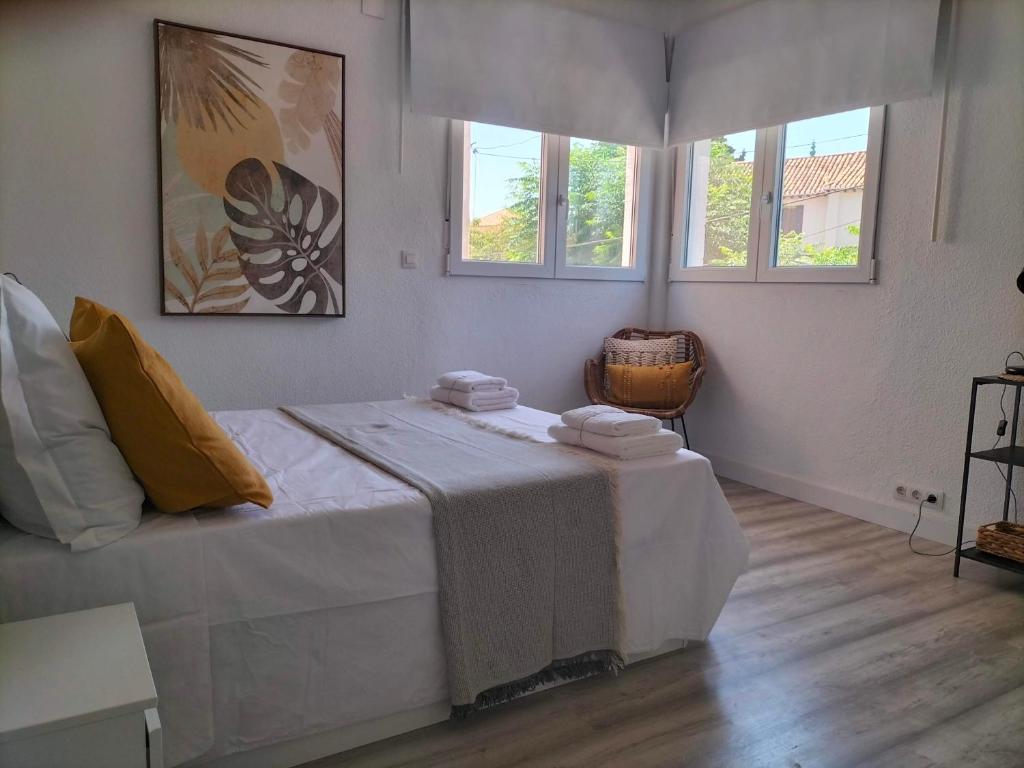a bedroom with a large bed with towels on it at La Mansión del Toledano in Granada