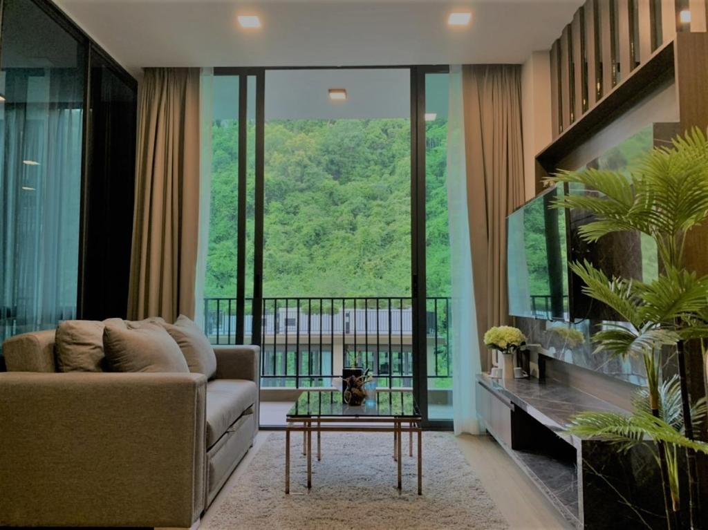 a living room with a couch and a table at A2 at Forest Khaoyai in Ban Huai Sok Noi