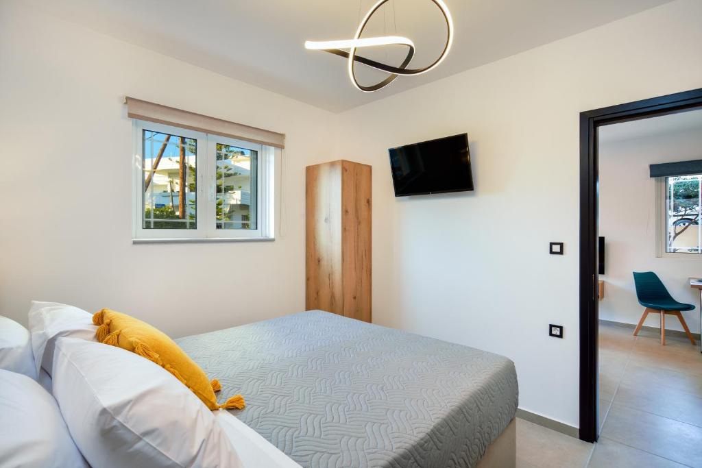 a bedroom with a bed and a flat screen tv at Xenia's apartment in Ayiá