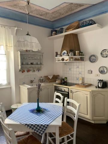 a kitchen with a table and a table and chairs at Apartment Hisa 7 Piran in Piran