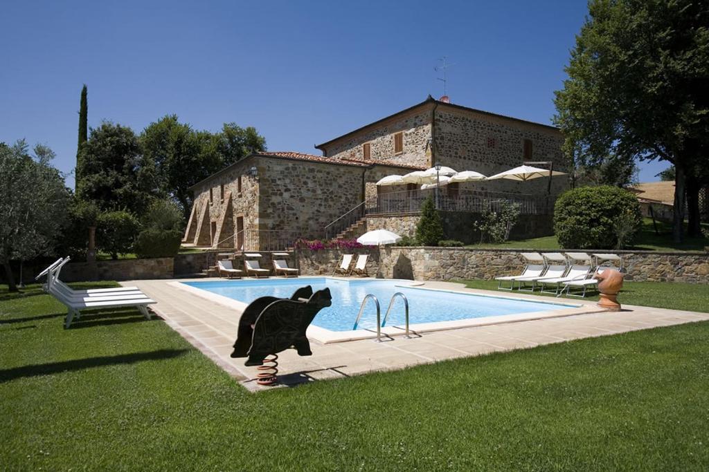 a statue of a cat on a skateboard by a pool at Agriturismo Belagaggio in Montefollonico