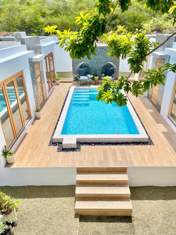 a swimming pool in the middle of a house at Moringa Resort - Studio A with Pool open air shower & Bath in Willemstad