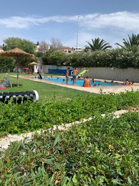 a group of people playing in a swimming pool at Hanae malabata in Tangier