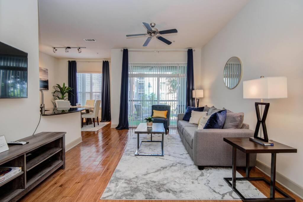 a living room with a couch and a ceiling fan at Smoke Free Amazing Modern 1 BD near NRG in Houston