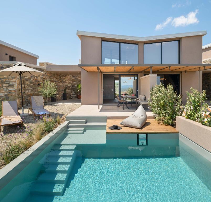 a house with a swimming pool in front of a house at Etheres in Nikiti