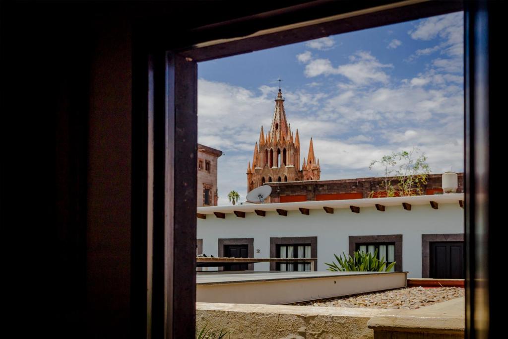 a view from a window of a building and a cathedral at Hotel Boutique Hacienda Guadalupe in San Miguel de Allende