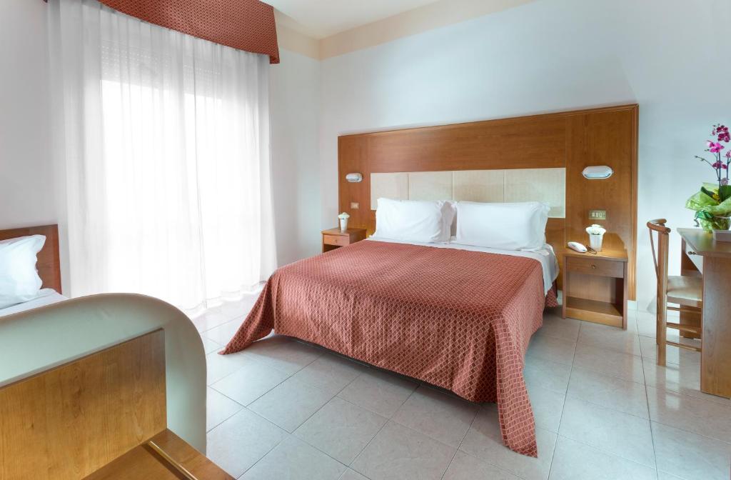 Postel nebo postele na pokoji v ubytování Hotel Vela d'Oro