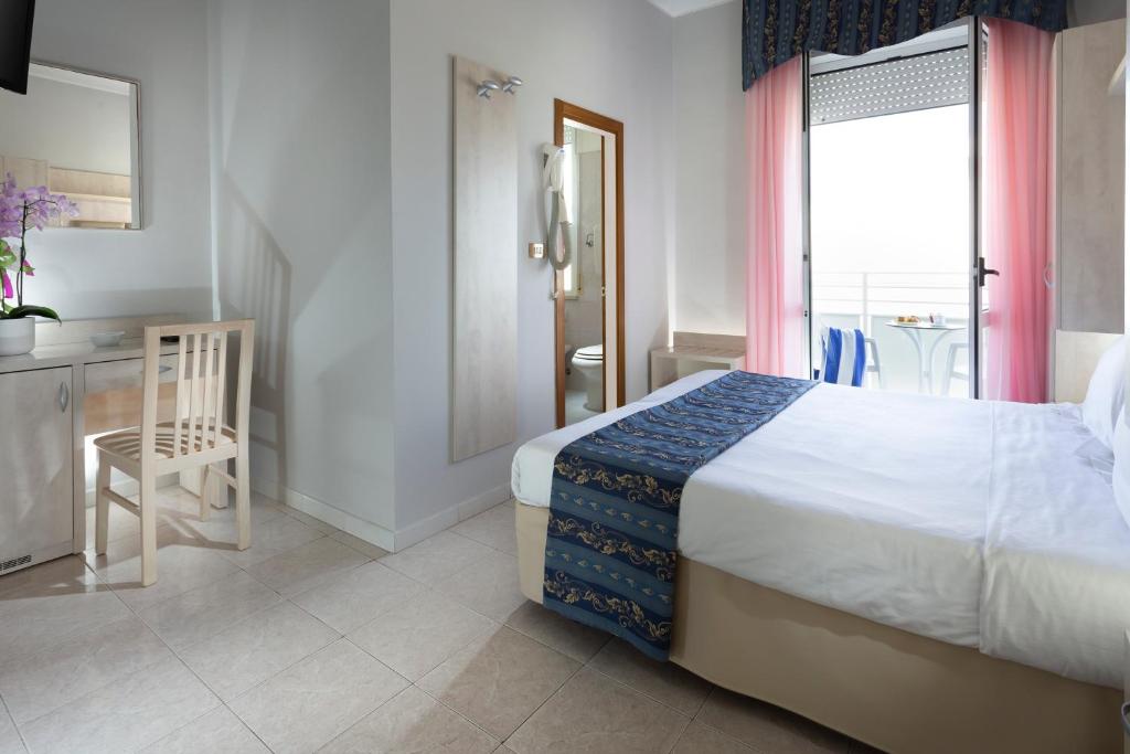 Postel nebo postele na pokoji v ubytování Hotel Vela d'Oro