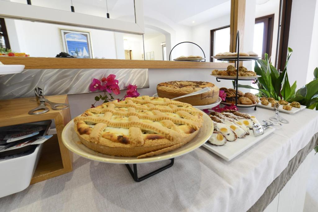 a table with a pie and other desserts on it at Best Western Hotel Martello in Lampedusa