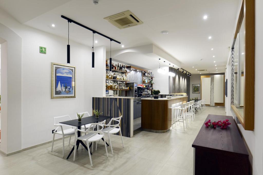 a restaurant with tables and chairs and a bar at Best Western Hotel Martello in Lampedusa
