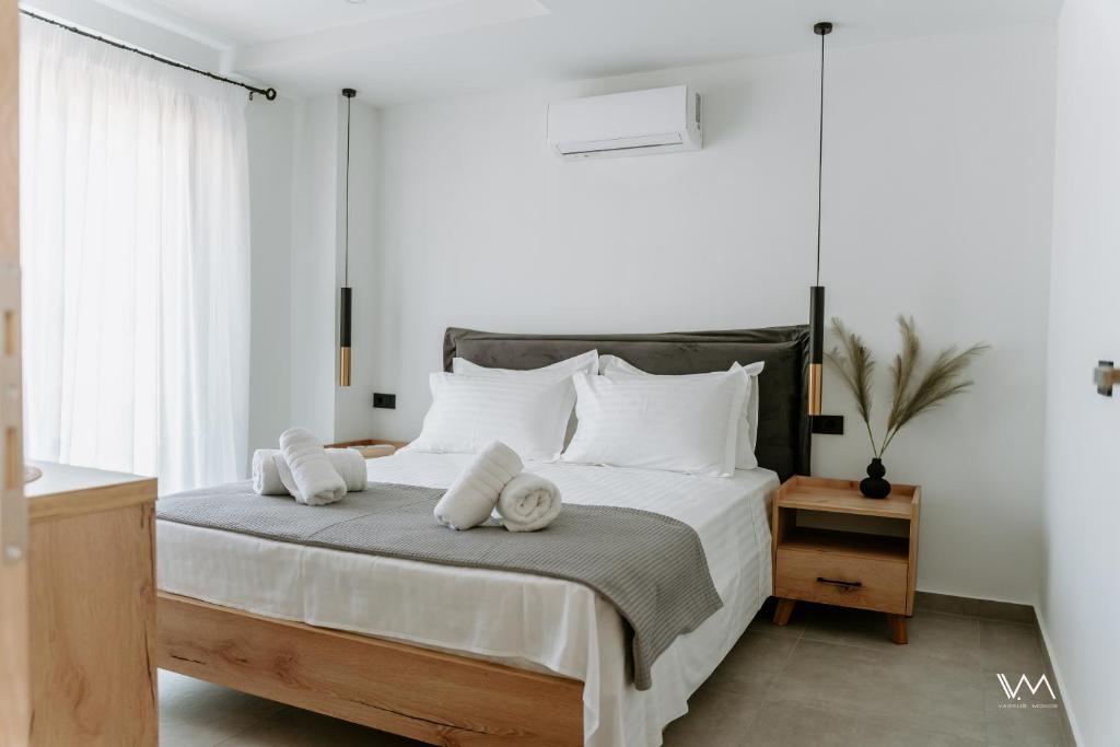 a bedroom with a bed with two towels on it at Elaionas Estate Perdika in Perdika