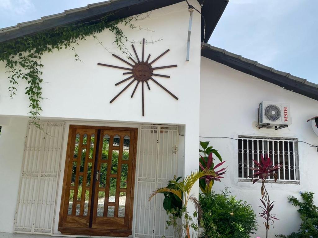 a building with a large clock on the side of it at Swiss Garden House in Kerr Sering With Full Private Compound in Amdalai