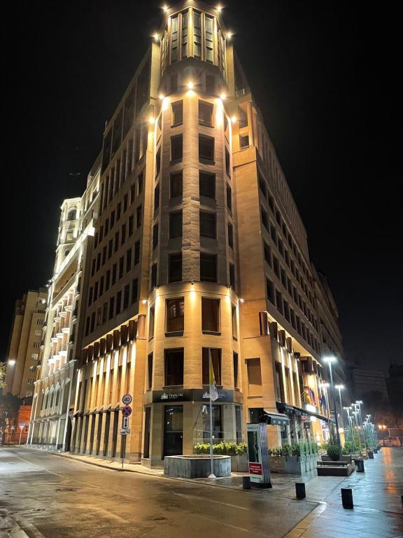 un edificio alto con luci sopra di esso di notte di AVENUE RESIDENCE by AY North Avenue a Yerevan