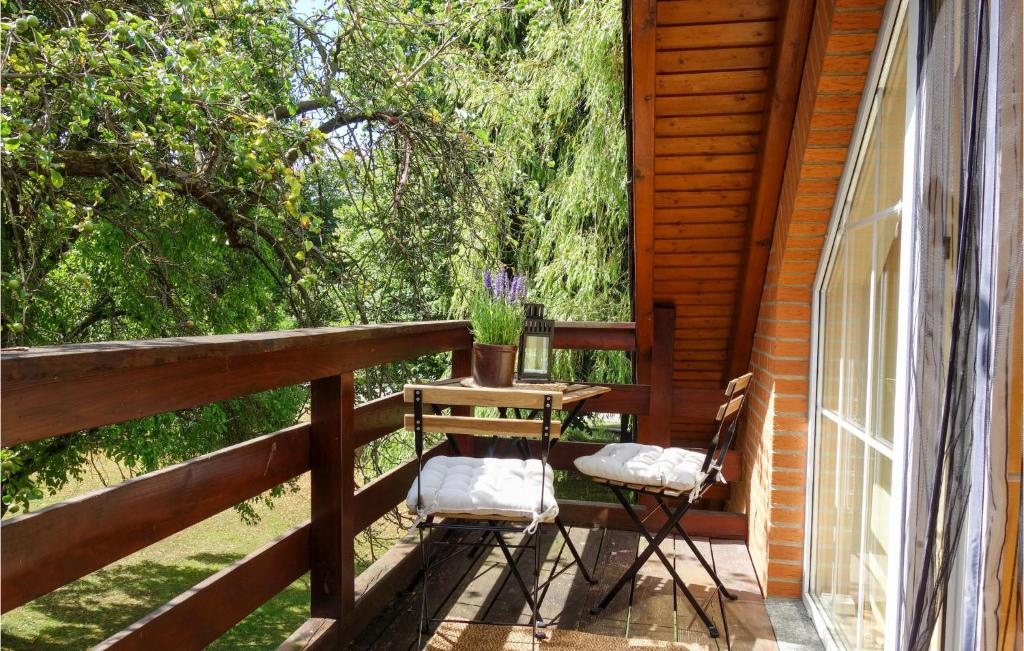 a porch with two chairs and a table on it at Gorgeous Home In Duingen With Wifi in Duingen