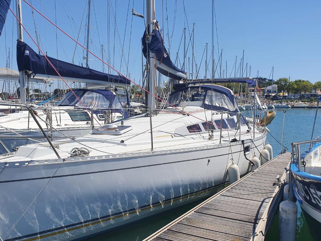 a white boat is docked at a dock at Voilier CALYPSO in La Rochelle