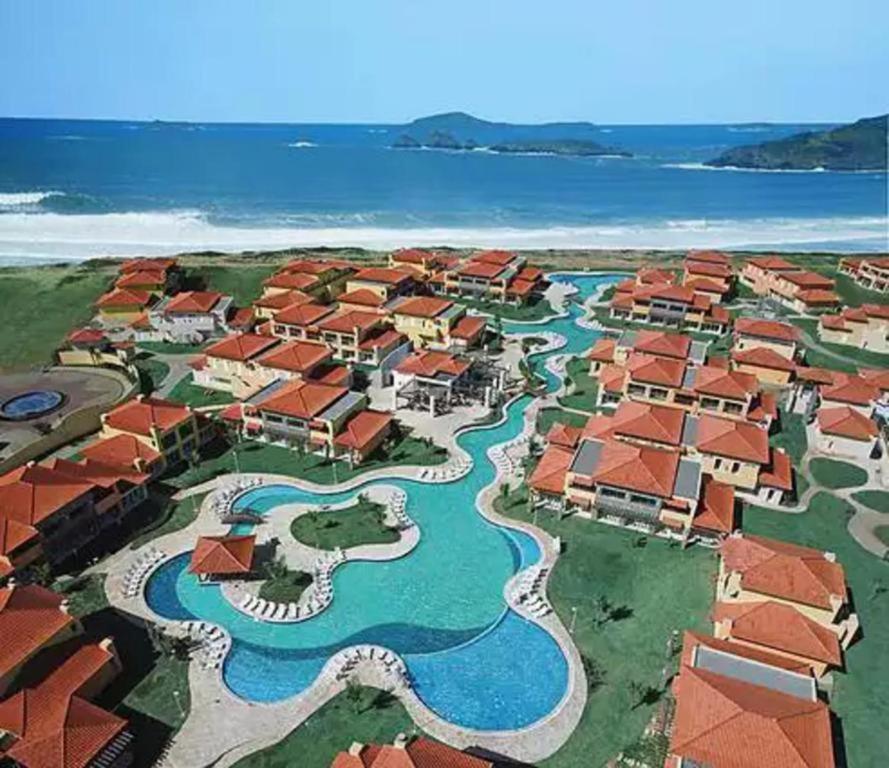 an aerial view of a resort with the water at Buzios Beach Resort Residencial super luxo 1307 in Búzios