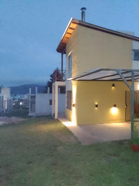a white house with lights on the side of it at Villa Aurora in Potrero de Garay