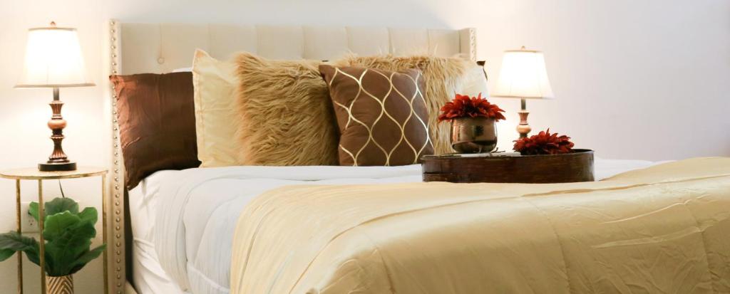 a bedroom with a white bed with two lamps at ELUXE @ Riveroaks in Houston