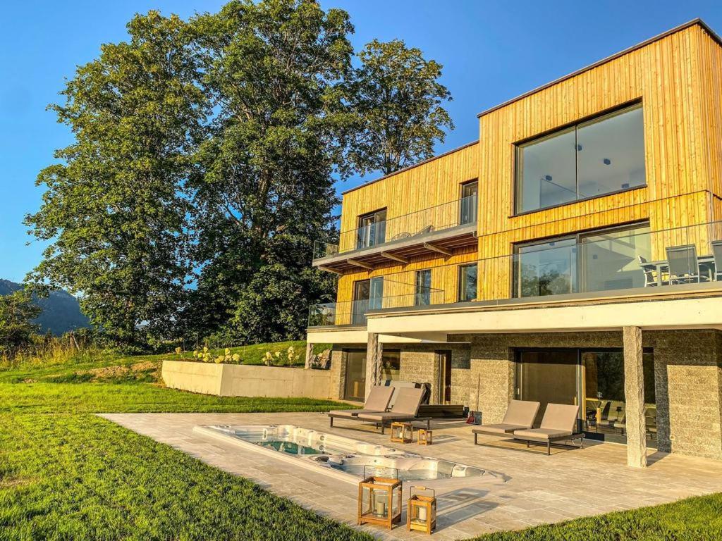 a house with two chairs and a pool at Ferienvilla Joachimsberg mit Swimspa und Sauna in Wienerbruck