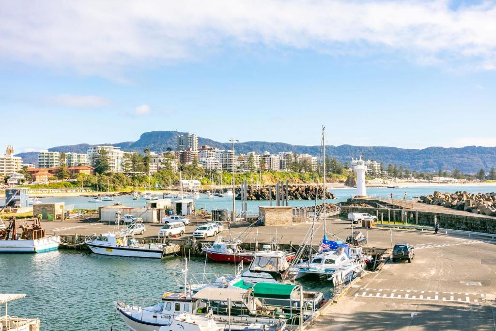a group of boats docked in a harbor at Modern 2BR Apartment near Wollongong Beach in Wollongong