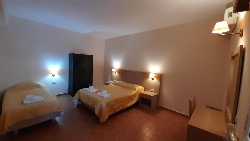 Postel nebo postele na pokoji v ubytování Lassi Hotel