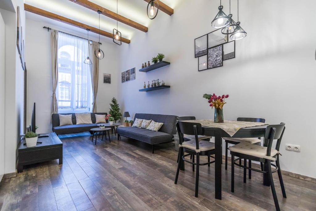 - un salon avec un canapé et une table dans l'établissement Katarina Apartment Blaha Square, à Budapest