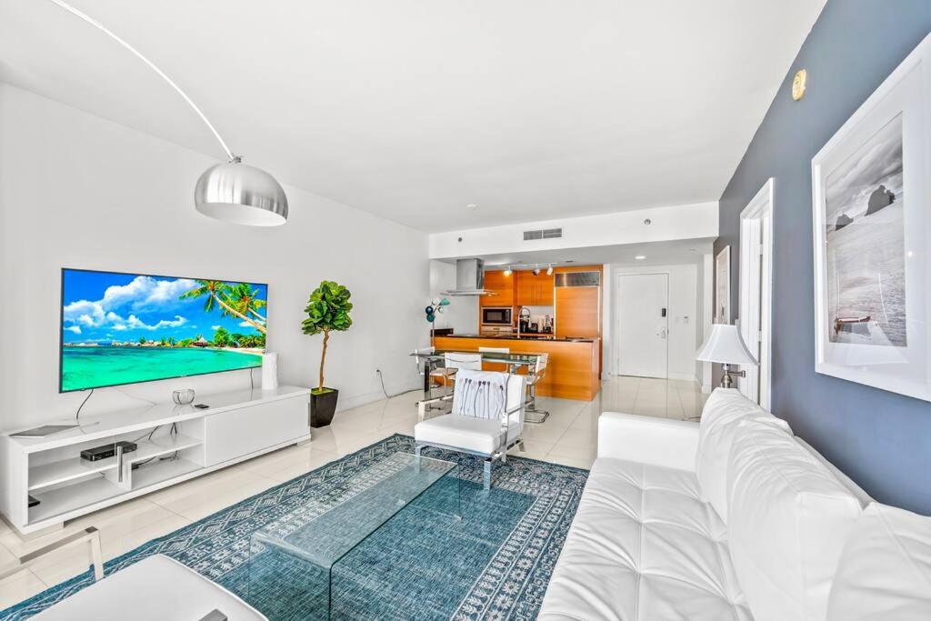 a living room with a white couch and a tv at Gorgeous Unit At The W Building Priceless Location in Miami