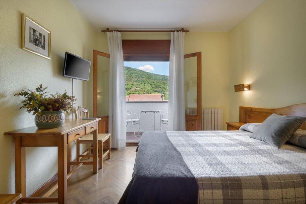 Postel nebo postele na pokoji v ubytování Hotel Lo Foraton