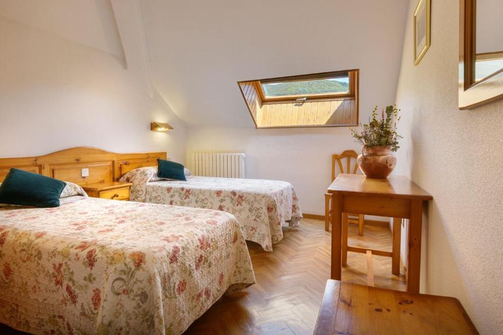 Postel nebo postele na pokoji v ubytování Hotel Lo Foraton