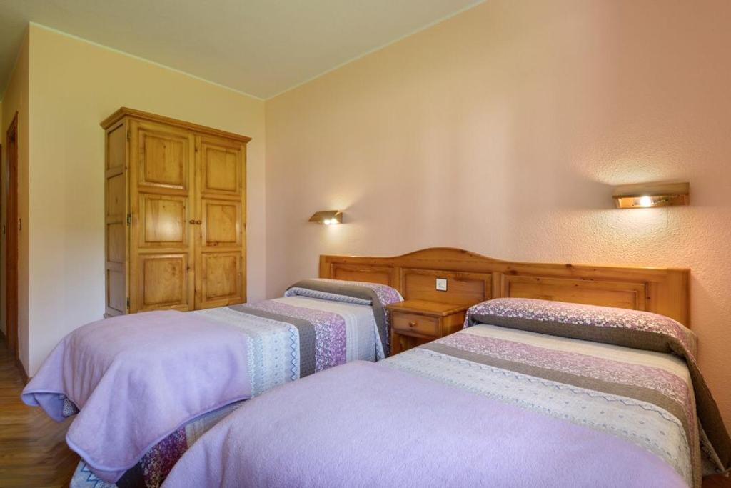 Postel nebo postele na pokoji v ubytování Hotel Lo Foraton