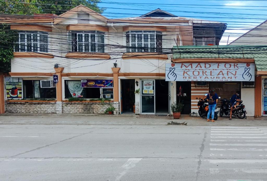 a building with a sign for a korean restaurant at RedDoorz @ Plaza La Paz Iloilo City in Iloilo City