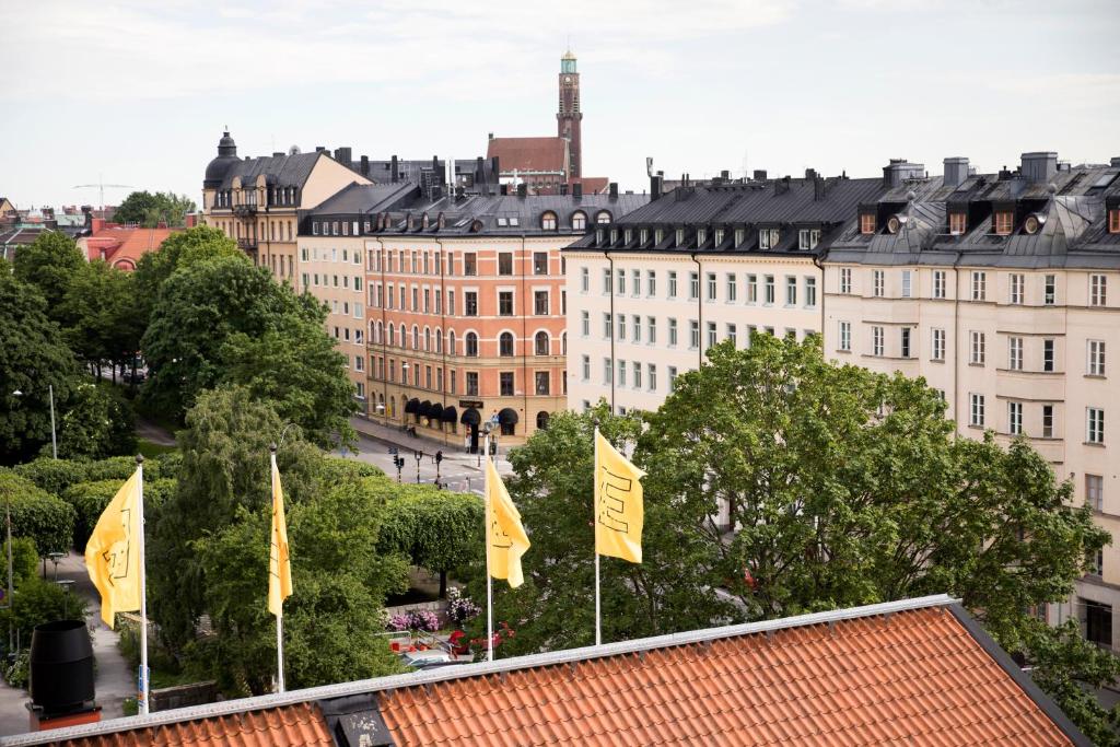 a large building with a flag on top of it at Elite Hotel Arcadia in Stockholm