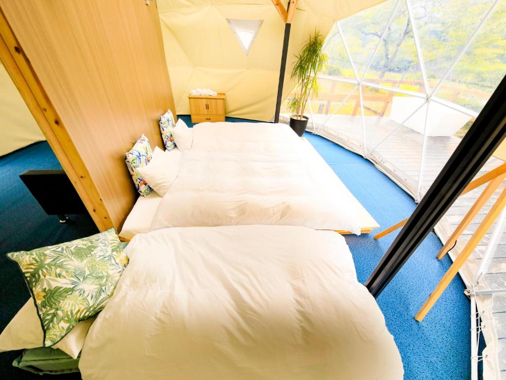 Postel nebo postele na pokoji v ubytování SPRINGS VILLAGE 足柄 丹沢温泉リゾート＆グランピング