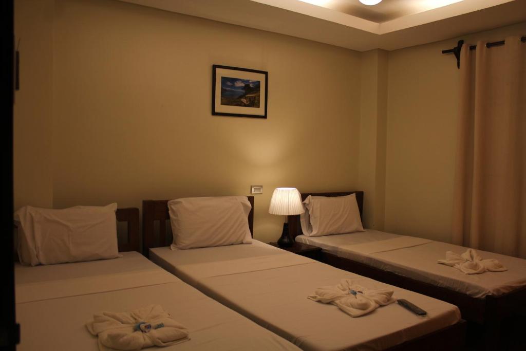 Postel nebo postele na pokoji v ubytování Aqua Travel Lodge