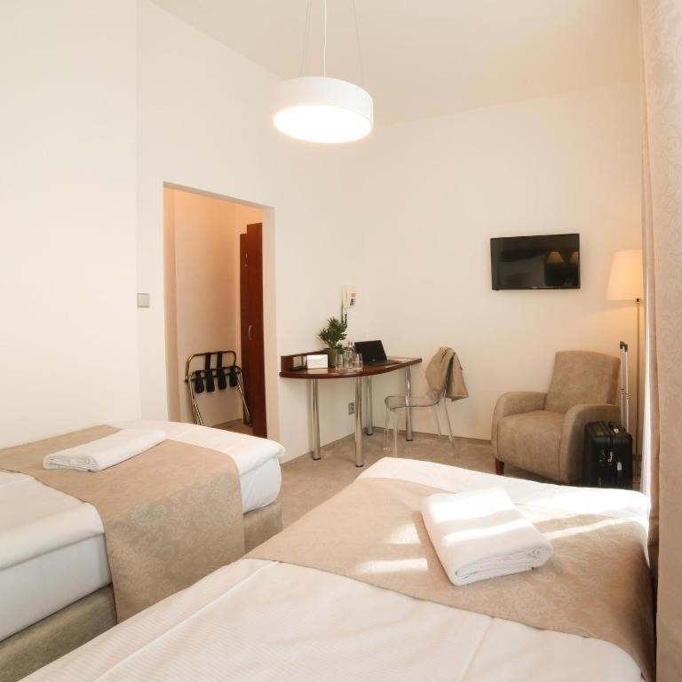 Postel nebo postele na pokoji v ubytování Hotel KOZÁK