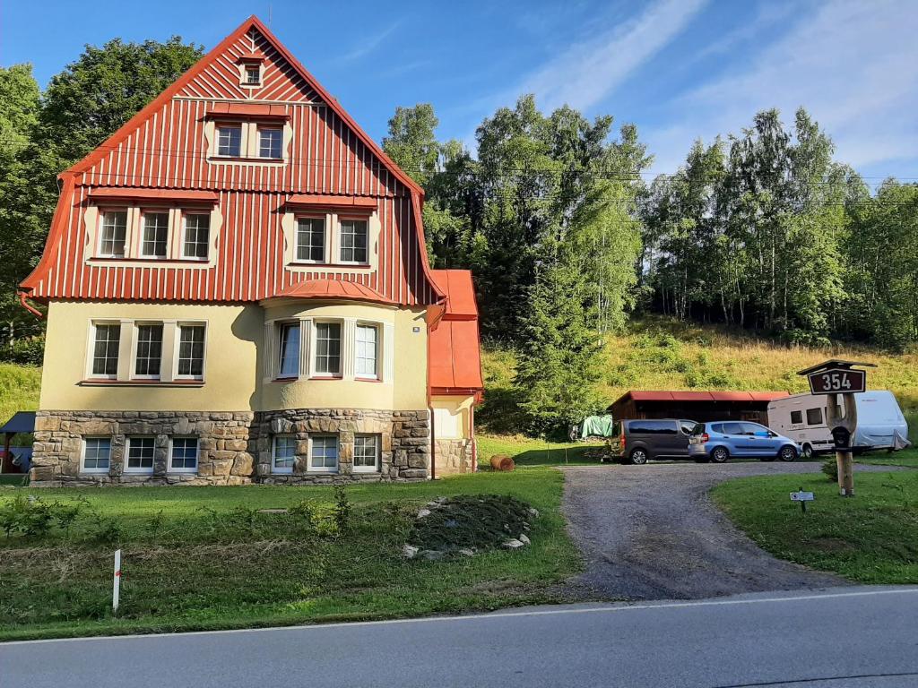 a house with an orange roof on the side of a road at Apartmán vila Vítkovice in Vítkovice