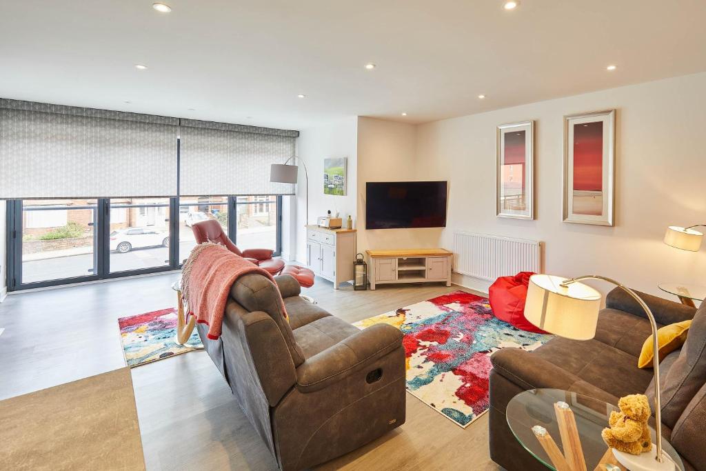 a living room with two couches and a tv at Host & Stay - Even Keel in Whitby