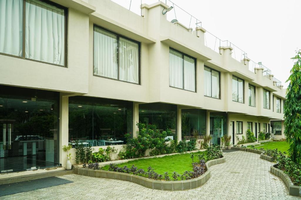 an external view of a building with a courtyard at Nest Beacon Resort Daman in Daman